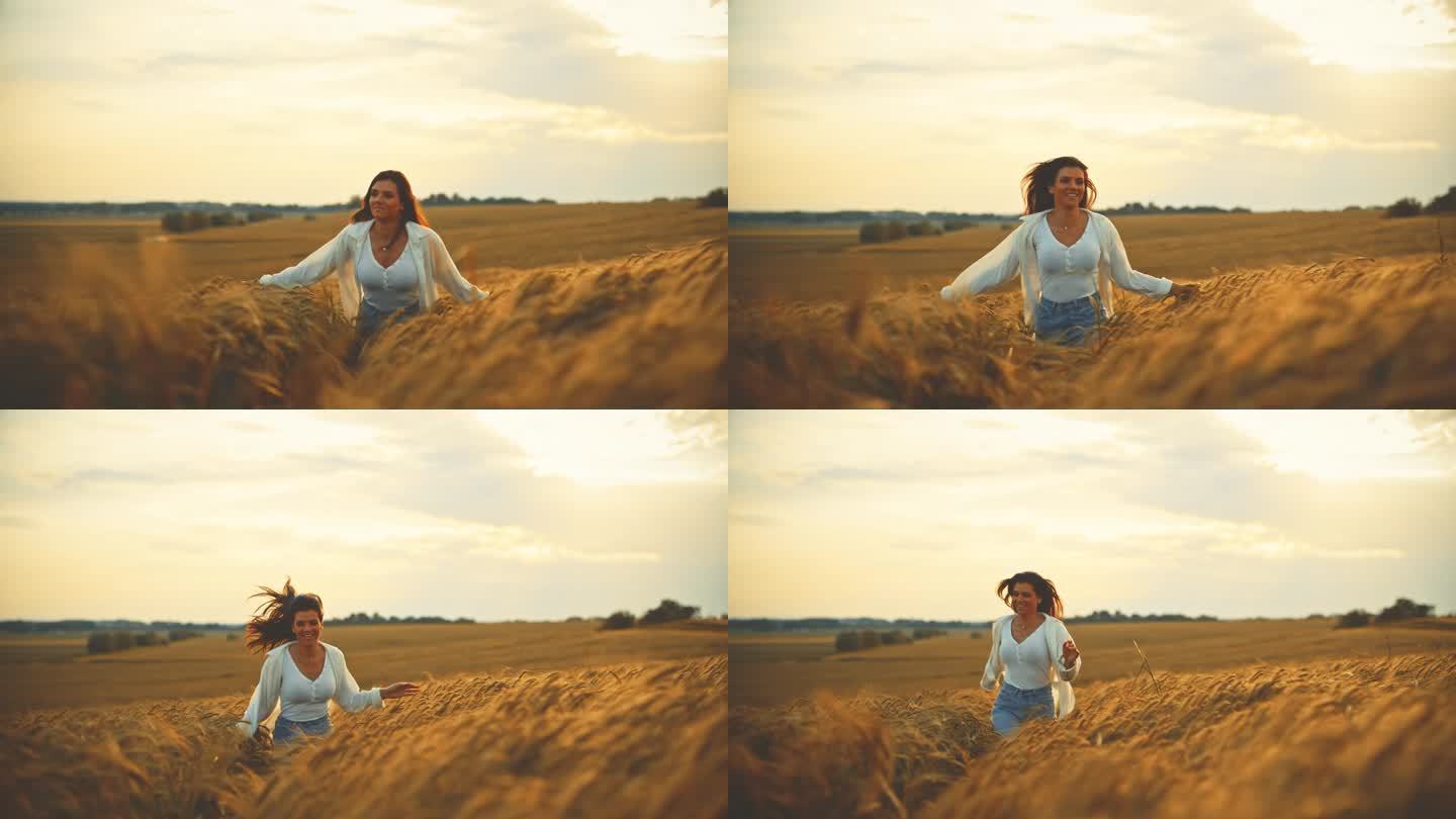 微笑的女人在小麦农场跑步，享受日落