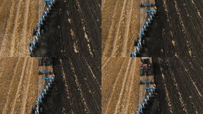 红色的大拖拉机开在橡胶履带上，在田地里拉着多产的反耕犁。为种植新作物准备土壤，农业。拖拉机田间耕作的