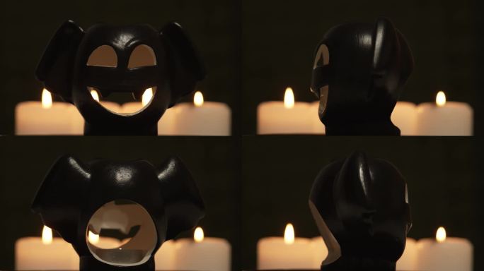 万圣节的装饰有燃烧的蜡烛和旋转的蝙蝠魔鬼怪物头，在晚上带着可怕的笑容