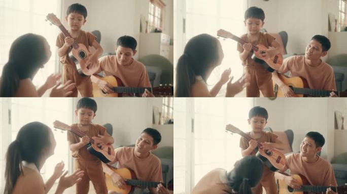 音乐时刻:亚洲父母和孩子在家里享受吉他游戏时光。