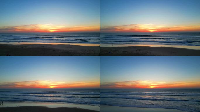 葡萄牙卡斯凯伊斯，一只海鸥飞向大海，落日映照在沙滩上