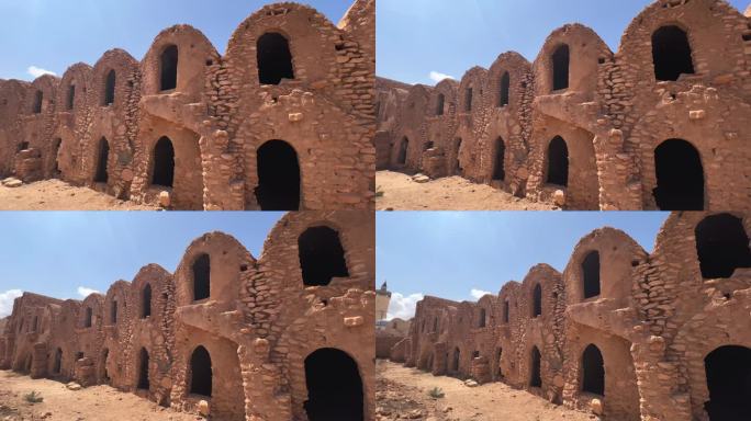 在突尼斯，Ksar Hadada粮仓废墟与清真寺为背景。平移