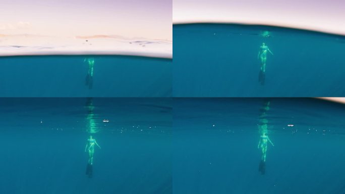 日落时分，女自由潜水员在水下游泳，慢慢地接近水面
