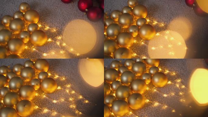 圣诞装饰品隐藏在散焦灯后面。从灯泡的散焦光增加了节日的心情和多样性的背景，你的圣诞视频。