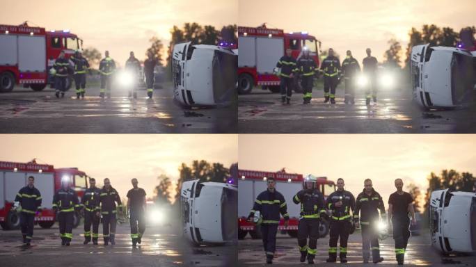 勇敢的消防队员走向镜头。背景:救护人员和消防员救援队在车祸中救火，保险和救人的理念。