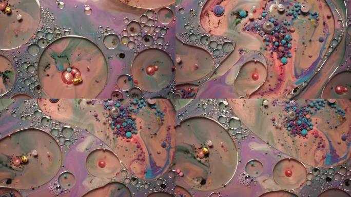 彩虹泡泡的油漆和墨水在水中。五颜六色的液体不停地旋转和混合