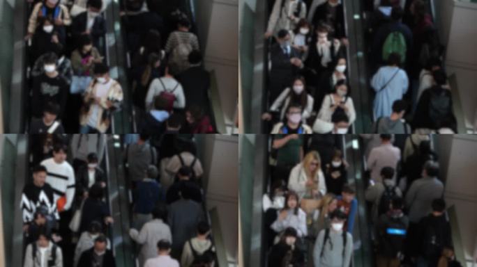 模糊散焦的人们在东京商场使用自动扶梯，日本的购物者