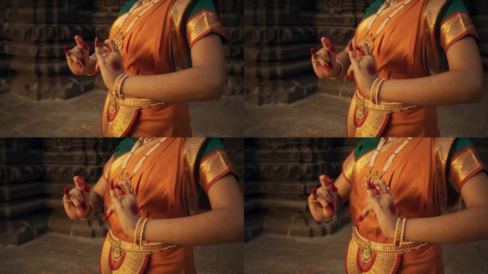 一个印度女舞者的手在民间舞蹈中表现出象征性的手势，传递着信息。穿着传统纱丽的女孩展示手印运动的艺术