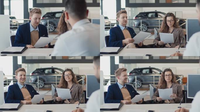 年轻夫妇在汽车经销店阅读汽车销售合同条款