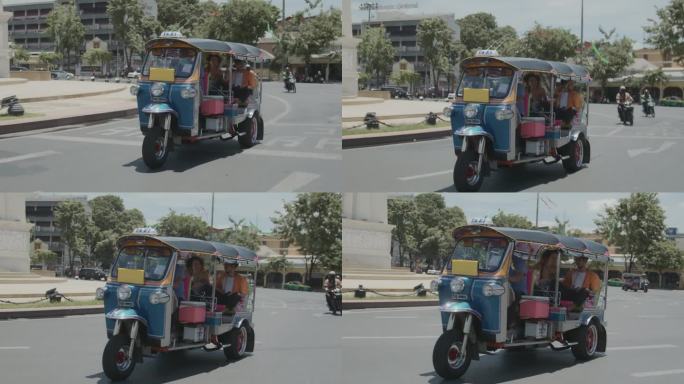 一对年轻夫妇在曼谷愉快地乘坐电动嘟嘟车。