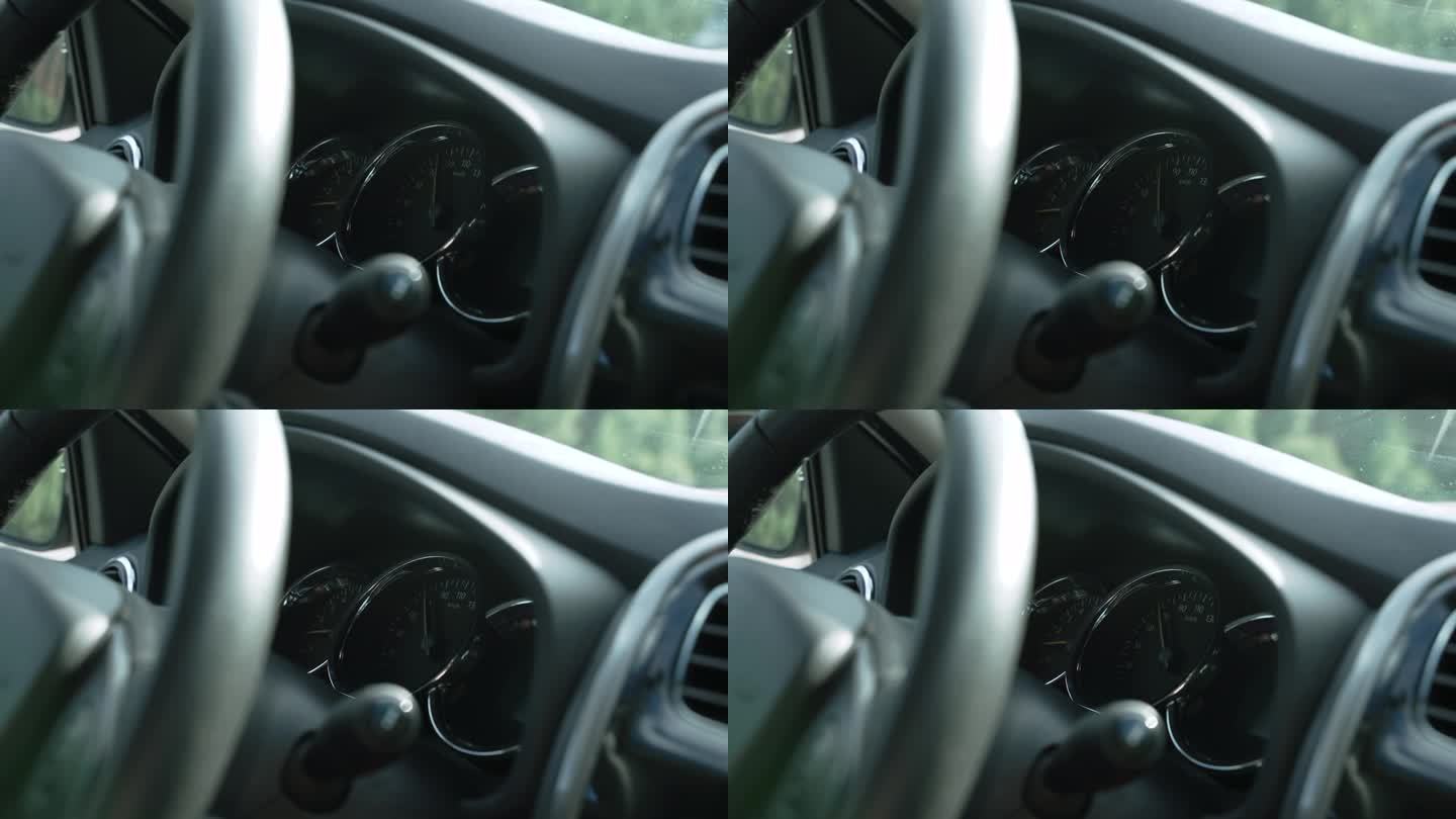 在汽车行驶过程中，转速表上的箭头平稳下降，特写。