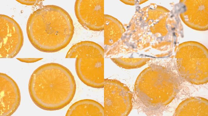 俯拍水泼向白背景上的橙子切片 慢镜头合集