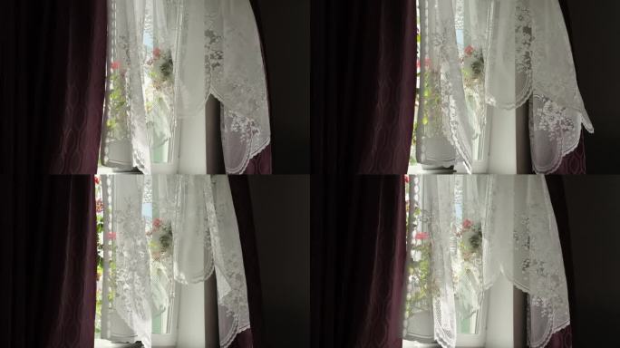 阳光照射在蕾丝窗帘上，投射出复杂的阴影，同时突出了窗台上的花朵