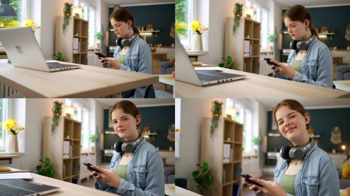 一个十几岁的女孩坐在书桌前使用智能手机的肖像