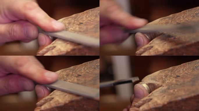 金匠珠宝商在工作台上用一把锉刀打磨未完成的戒指