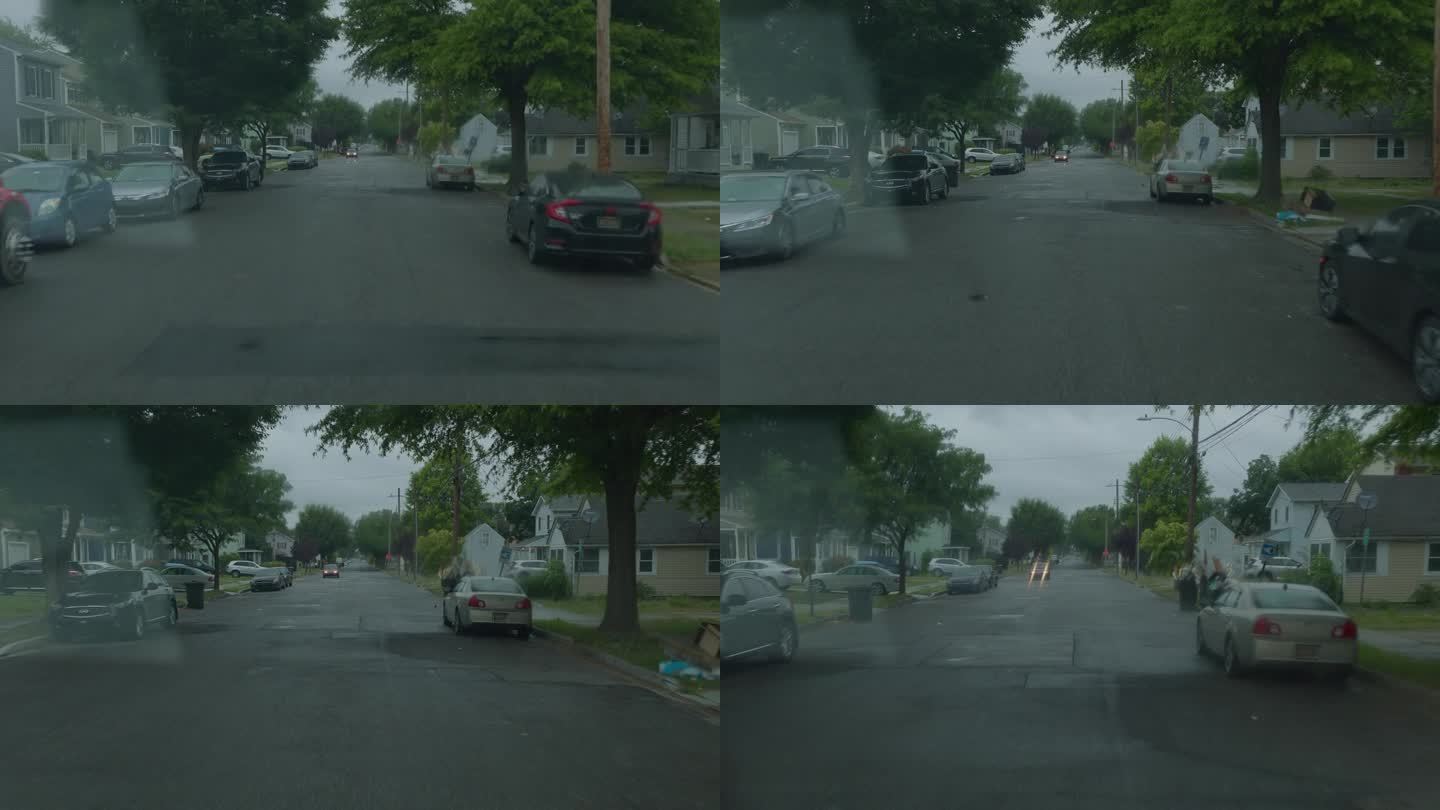多佛尔住宅区正在下雨。汽车停在树下避雨。驾驶板，道路视角，挡风玻璃照明弹