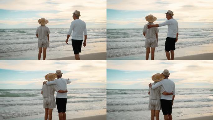 一对老夫妇在海边度假时拥抱在一起。