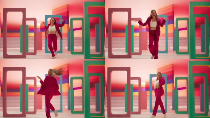 时尚的专业女舞者表演一个现代舞蹈套路前的大Led墙屏幕与彩色条纹背景在虚拟制作的工作室环境