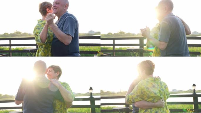 快乐的老年夫妇在夏日夕阳下一起在户外跳舞