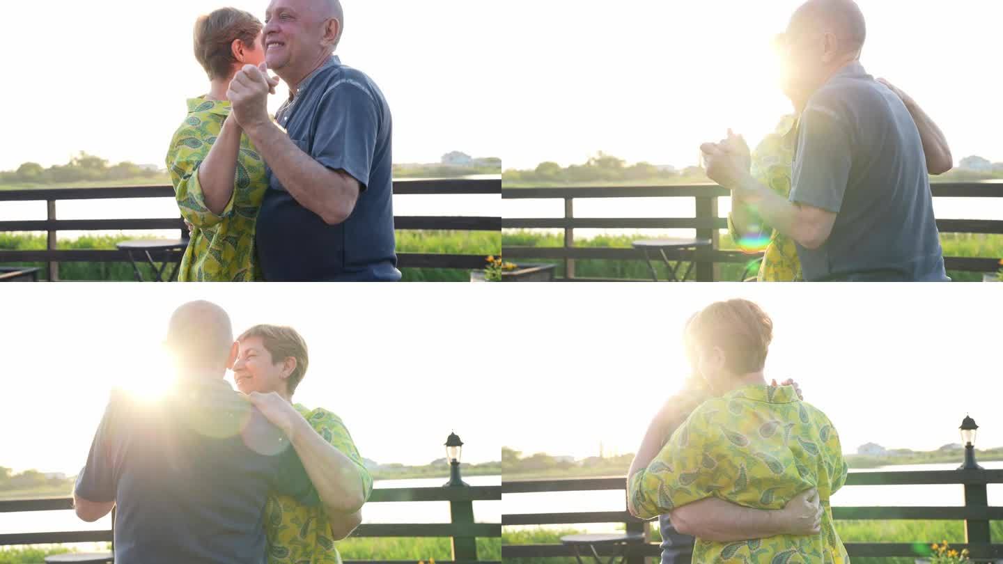 快乐的老年夫妇在夏日夕阳下一起在户外跳舞