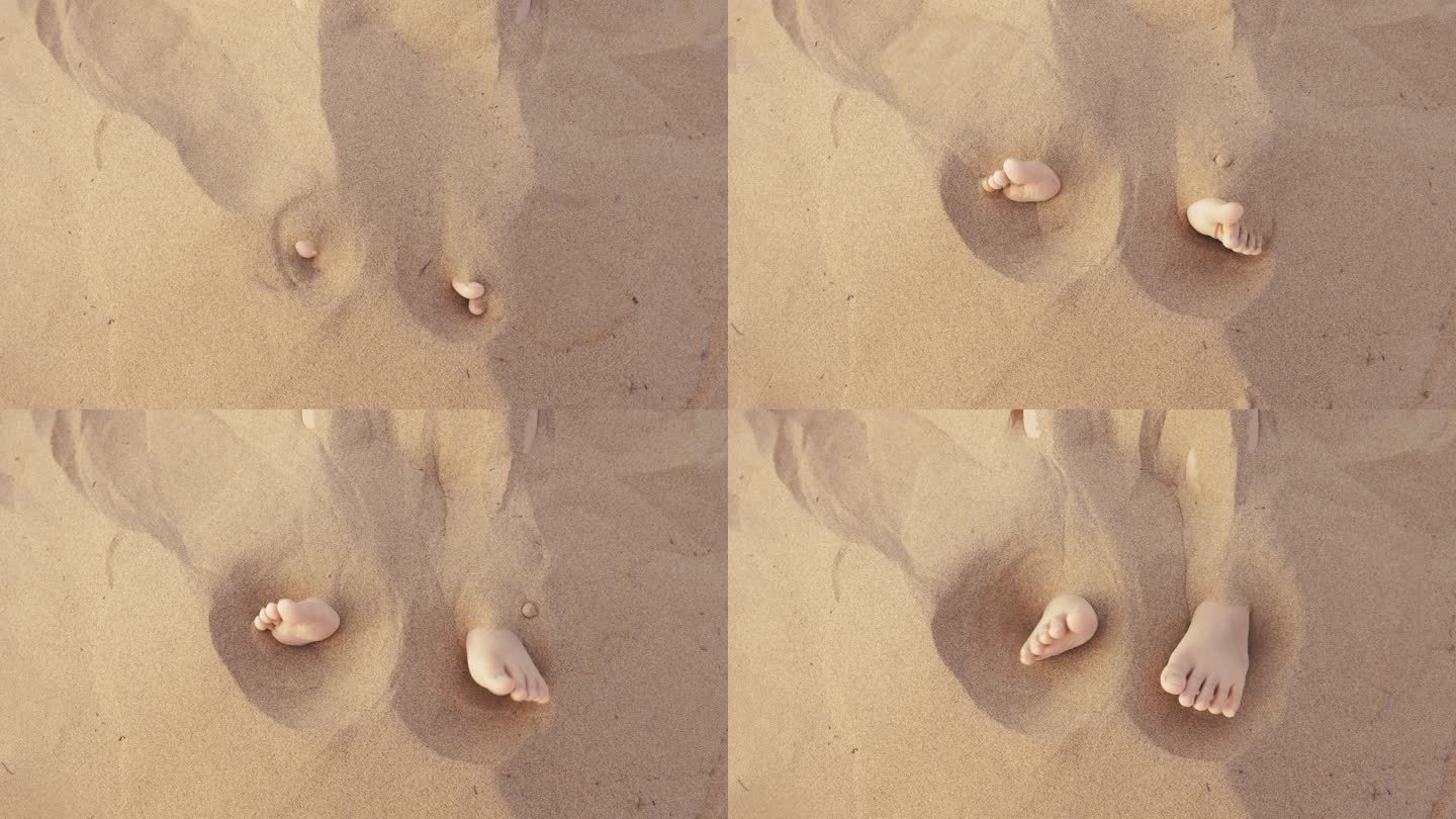 海边沙子里慢慢露出一双小孩可爱的脚