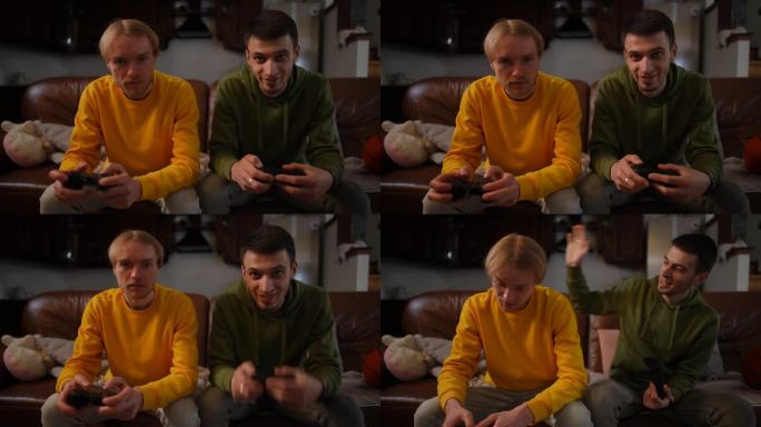 年轻人赢得了朋友玩电子游戏安慰男人拍肩膀。正面正面的白种人朋友在客厅里用摇杆坐在沙发上享受休闲时光。