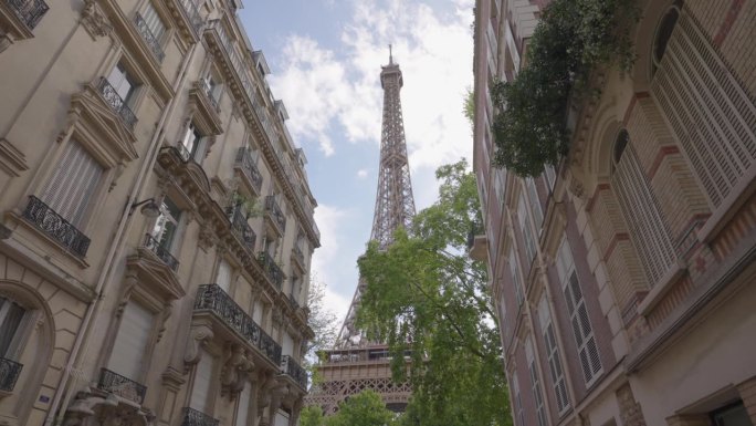 从巴黎一条著名的街道上俯瞰埃菲尔铁塔。位于首都中心的巴黎式房屋建筑。背景是巴黎的标志性建筑铁塔