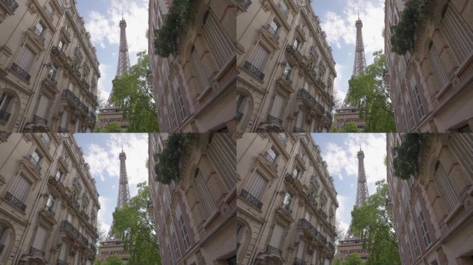 从巴黎一条著名的街道上俯瞰埃菲尔铁塔。位于首都中心的巴黎式房屋建筑。背景是巴黎的标志性建筑铁塔