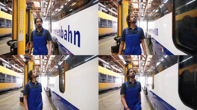 在铁路车间工作的非洲人正在检查地铁车厢的外观