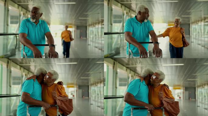 老夫妇在机场拥抱