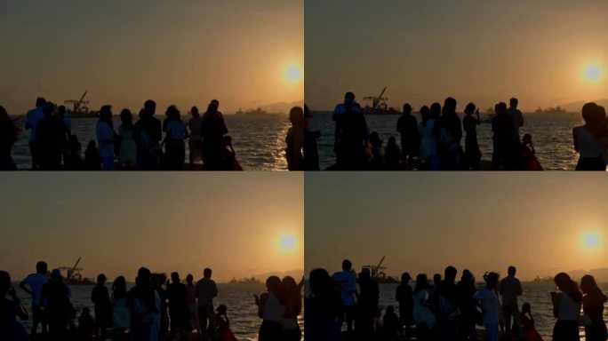 4K慢镜头人们在堤坝观看大海日落