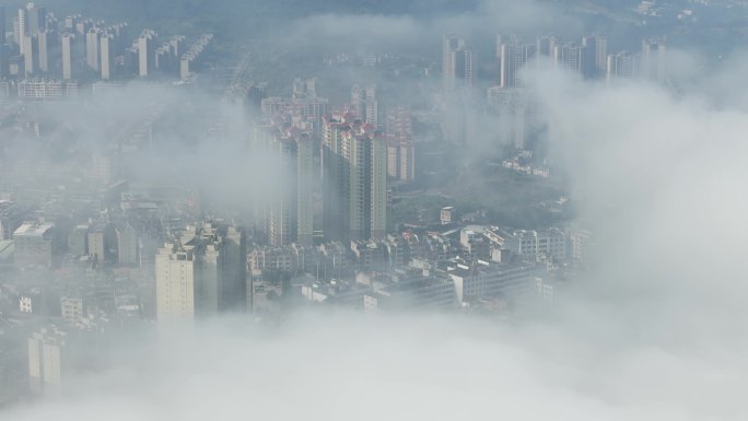 航拍视觉上升到流云面云下城市高楼