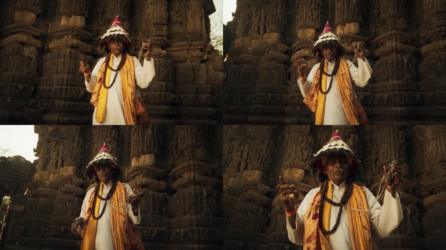 一个穿着传统服装的印度老人在古印度寺庙里演奏乐器的真实画像。节日老人用宗教音乐弘扬丰富的文化遗产
