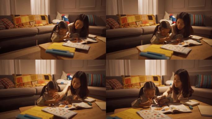 韩国母亲在家里的客厅里教女儿画画的照片。年轻女子帮助女儿做家庭作业，用创造力学习新单词