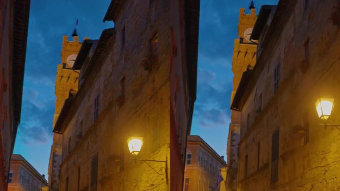 黄昏时分在镇上的钟楼下手持观景。意大利托斯卡纳的皮恩扎古镇