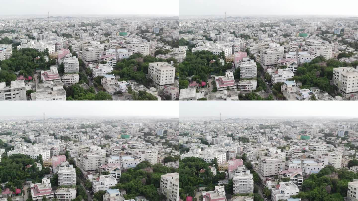 在印度早晨的一个城市的一个住宅区，4K分辨率的航拍画面。展示公寓和手机信号塔