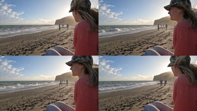 年轻女子望着空旷的沙滩，画像
