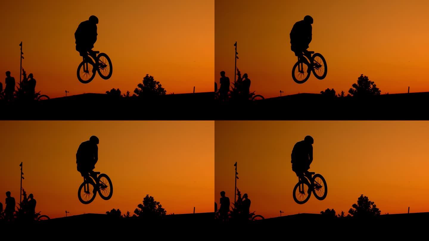 日落自行车飞跃年轻人