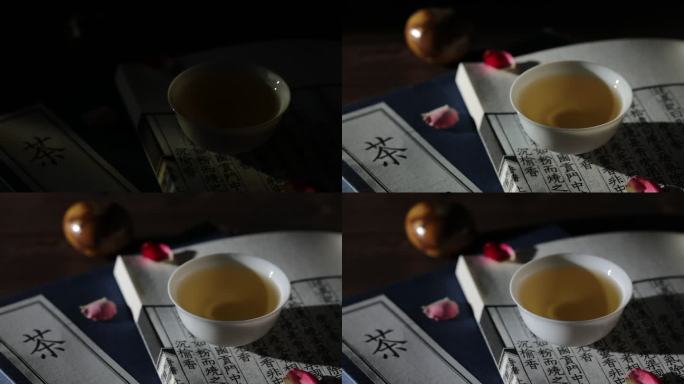 光线从古籍和茶杯上划过