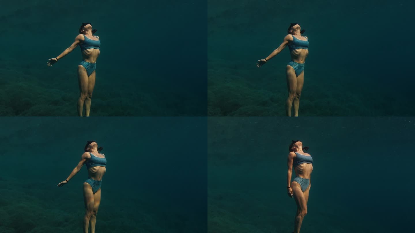 这是一段可循环播放的无缝画面，记录了这名女子在水下游泳，慢慢地接近水面