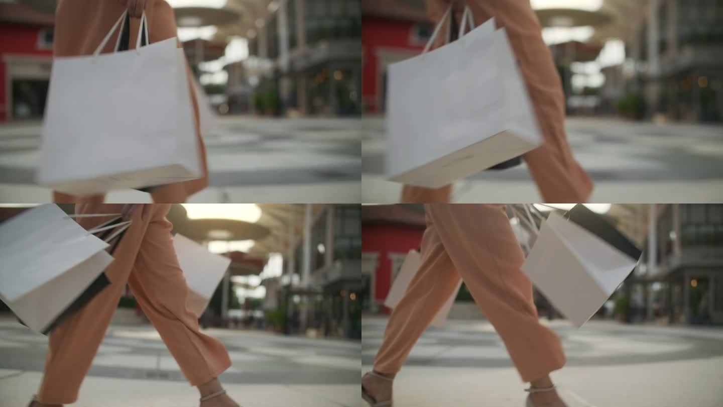 带着购物袋走在街上的女人