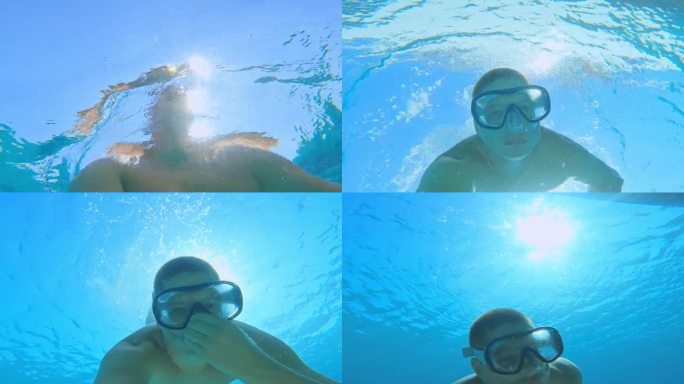 一名男子正在拍摄自己在绿松石海中一艘游艇下潜水的过程