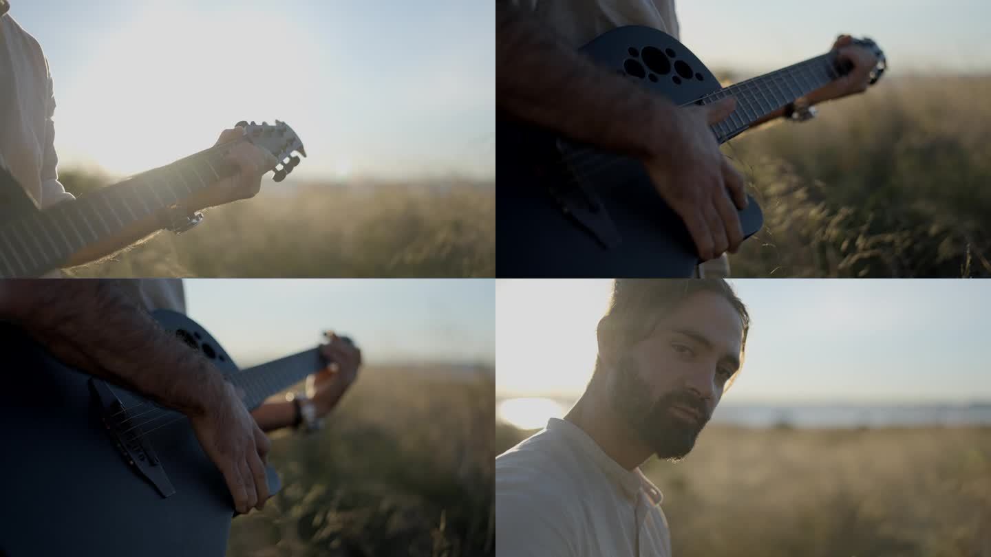 男吉他手在夕阳下的草地上弹奏吉他——背光镜头