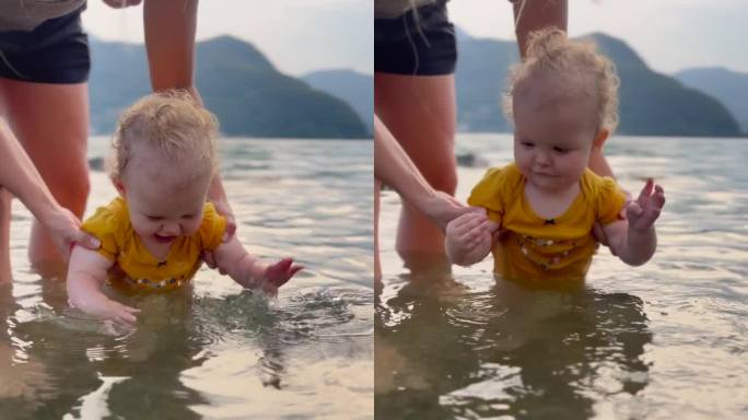 宝宝在湖边玩水，妈妈抱着她