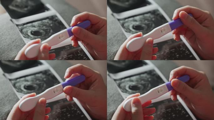 手握妊娠试验阳性超声片