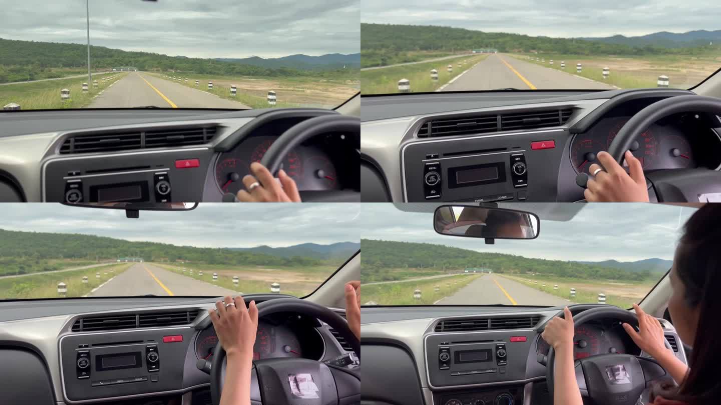 一个女人一边开车一边听音乐。