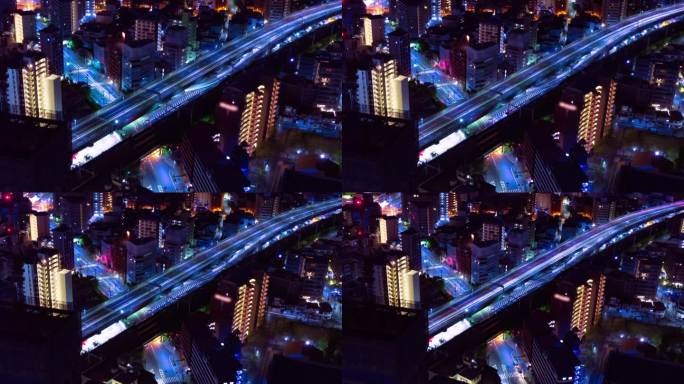 在大阪高速公路上的城市景观的夜间延时长焦镜头变焦