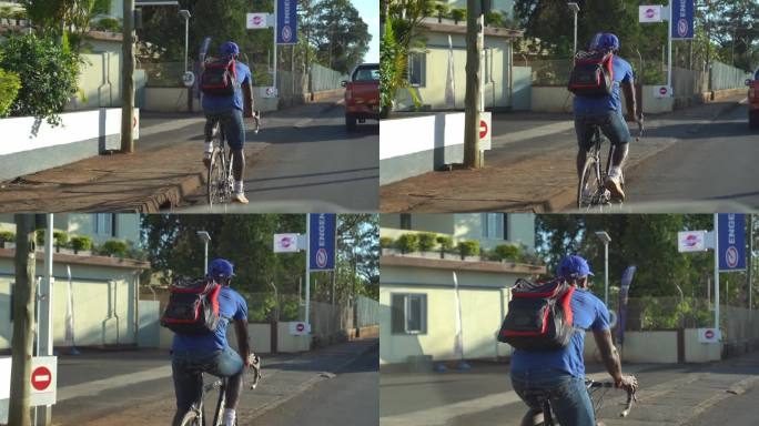 非洲街道上骑自行车的黑种人