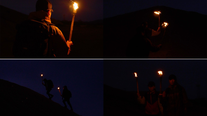 团队举着火把赶路-黑夜里举着火把徒步探险