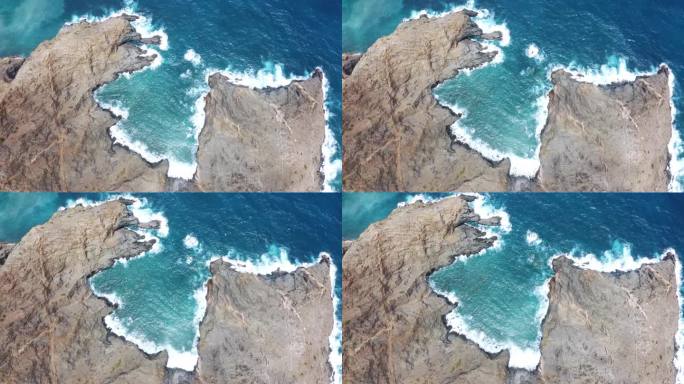 鸟瞰图在戈梅拉岛的一个遥远的岩石上，波浪在岩石上破碎。